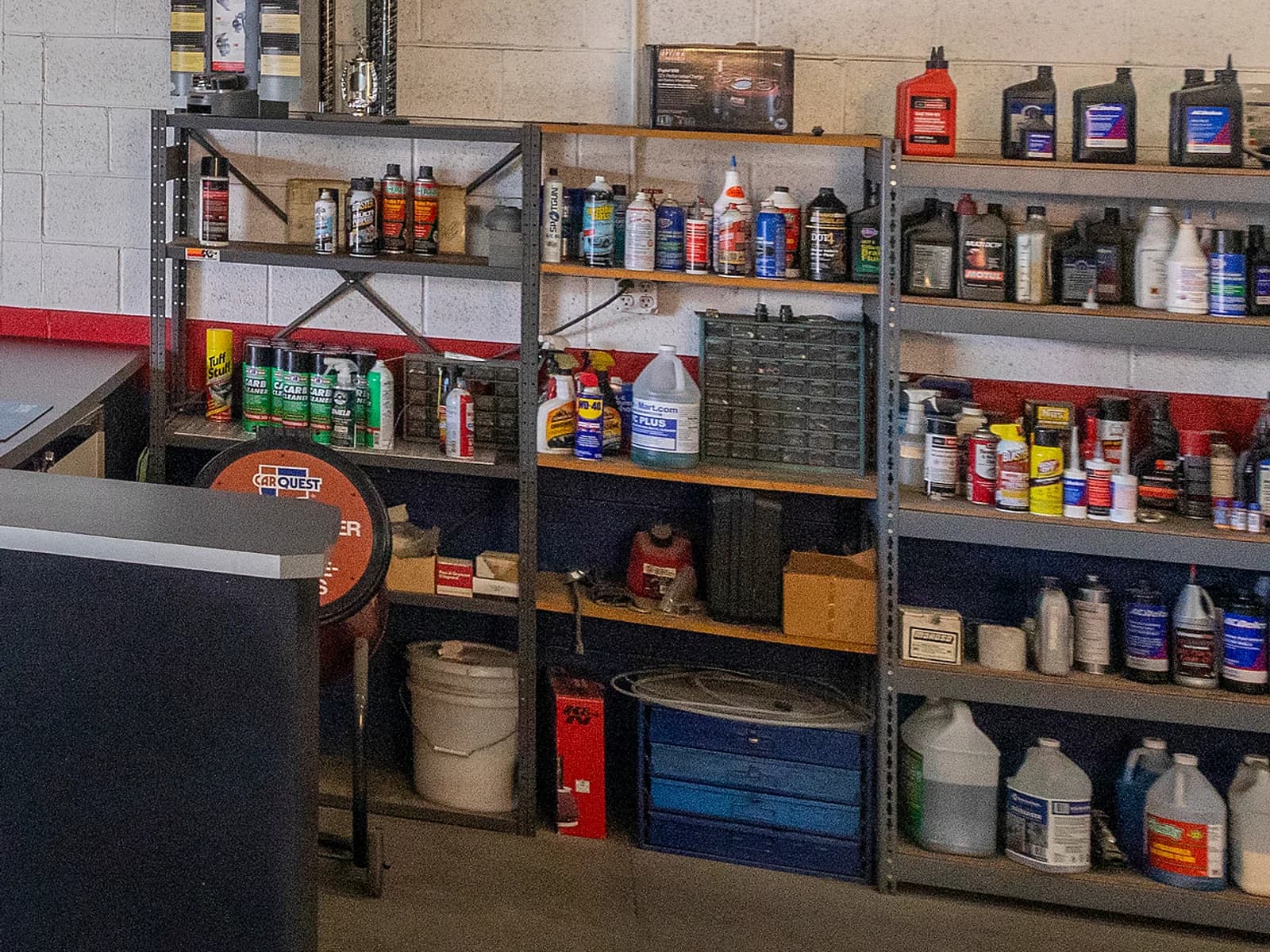 Shelves of oils, fluids and products behind the service counter