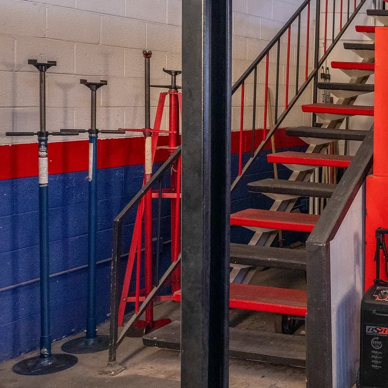 Jack stands and a steel staircase in the shop